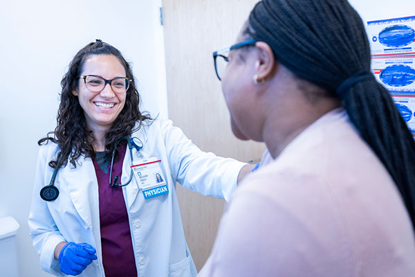 Cleveland Clinic doctor talking to a patient in an exam room.