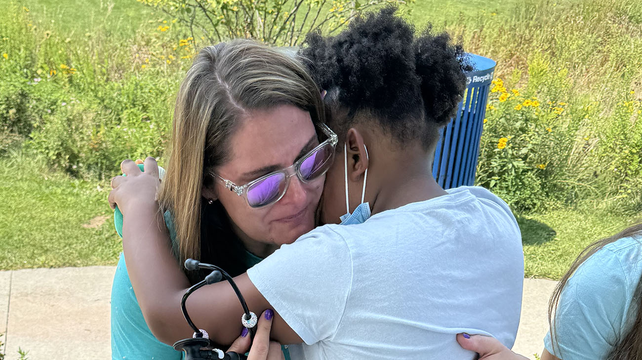 Mireya hugging Lisa after Lisa listened to Mireya's heart, the same heart as Lisa's late daughter, Maddy.